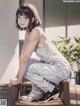 A woman sitting on top of a wooden chair.