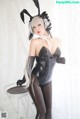 A woman in a black and white bunny costume posing for a picture.