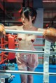 A woman in a boxing ring with boxing gloves on.