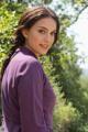 A woman in a purple dress posing for a picture.